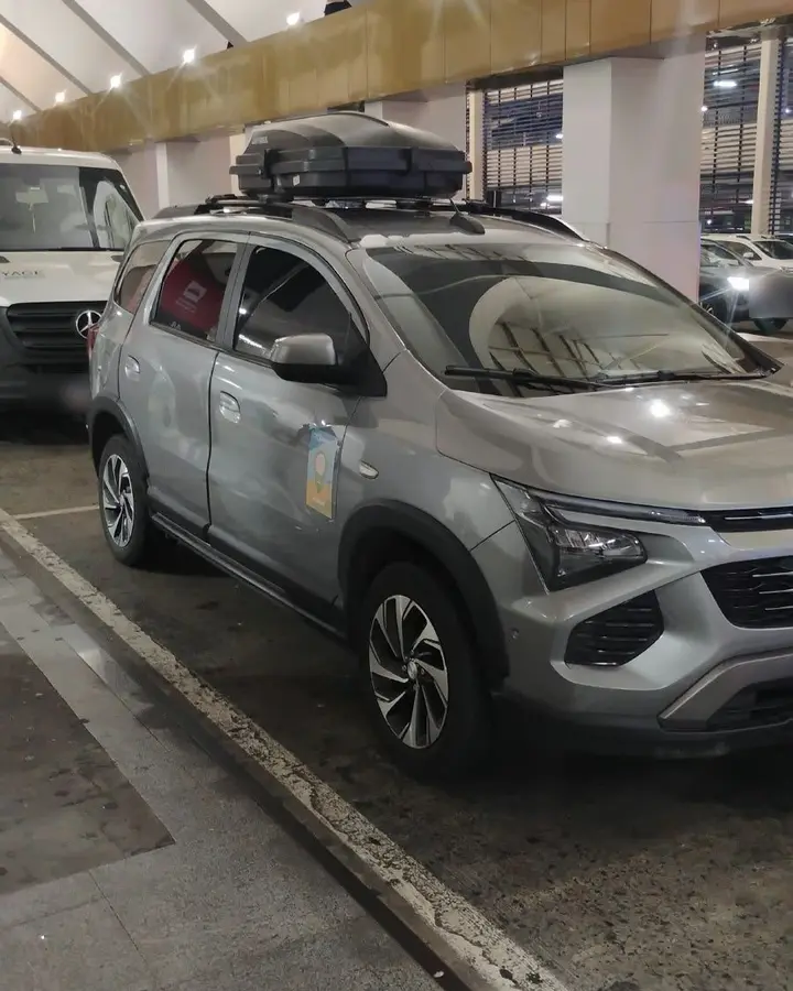 Carro cinza da Sameach, com o bagageiro no teto, no aeroporto